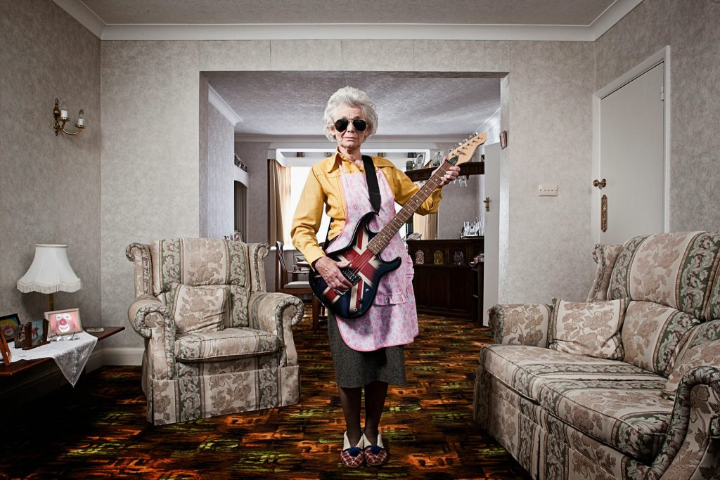 A cool old women playing electic guitar