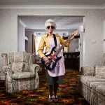 A cool old women playing electic guitar