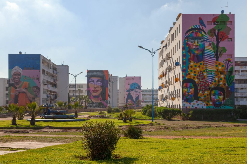 Casablanca, Morocco - January 20 2019: Housing Project in El Hank district with four of its buildings decorated with murals by Morrocan street artists. From left to right, "To the moon and back" by "Iramo", "Dream" by "Majid el Bahar", "Rebellous Teenager" by "Iramo" and "Dynam" and finally, "Mother Power" by "Okuda". The district of El Hank hosts many murals of this kind.