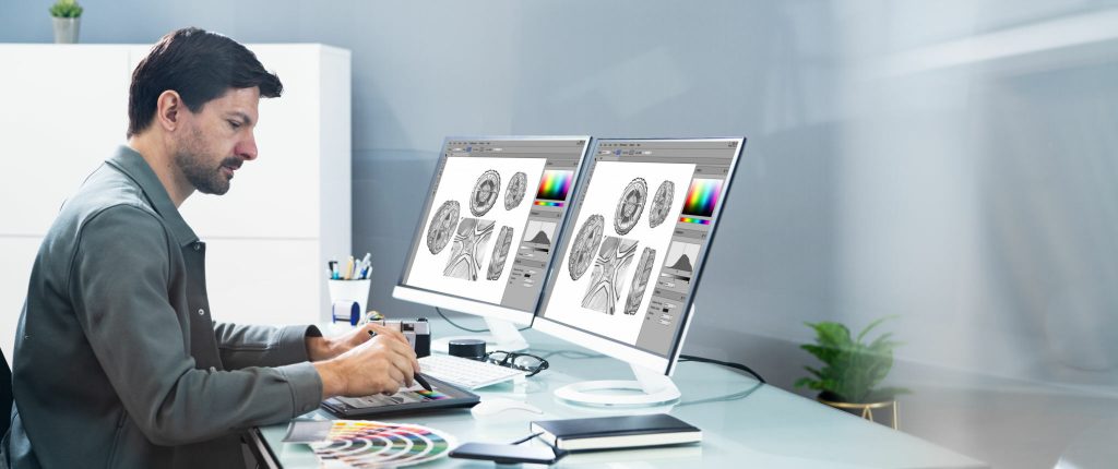 Graphic Photo Designer Using Computer Screen And Tablet