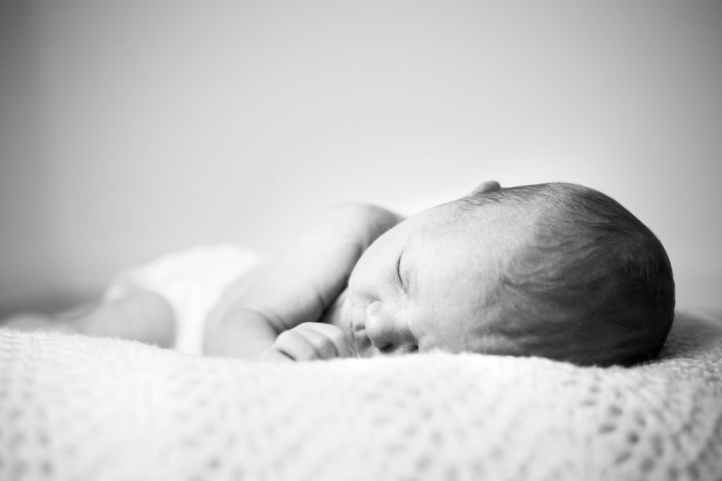 an image of a baby in deep slumber dreaming. 
